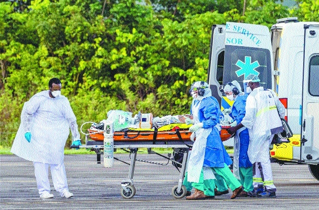 Medical staff carry a pat