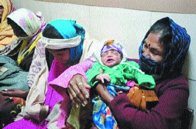 A woman holds her baby_1&