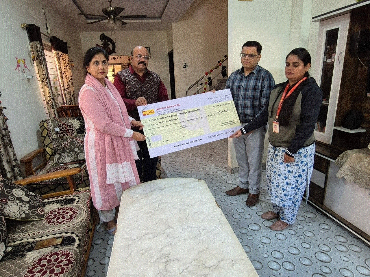 PNB officials handing over cheque