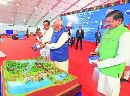 Prime Minister Narendra Modi pours Betwa river water over 