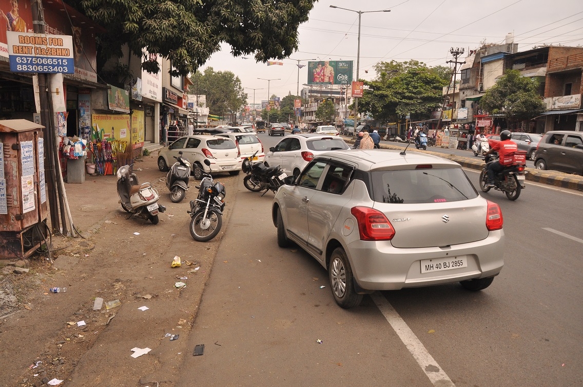 Vehicles of customers visiting local shops parked haphazardly along the Gittikhadan stretch