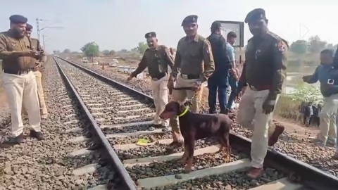 Police personnel during inspection of tracks a day after a train