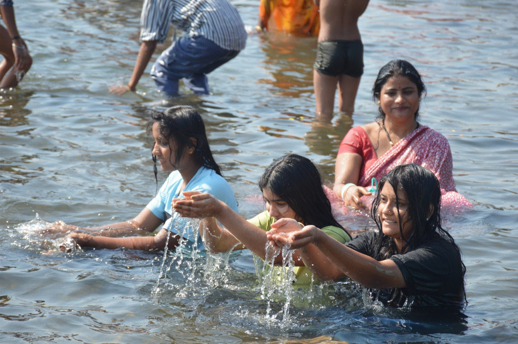 Youngsters womens taking a holy dip in river 