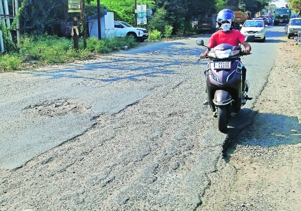 Commuters have to make their safe way by dodging the potholes