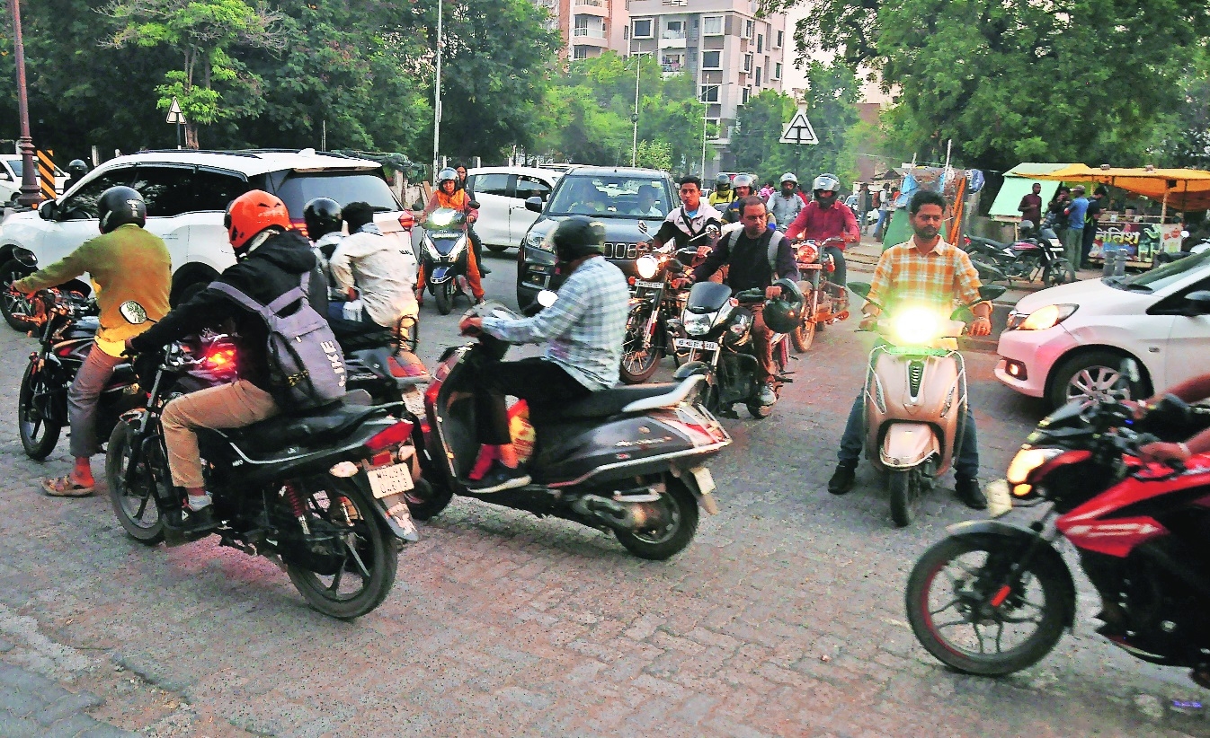 Two-wheeler riders trying to criss-cross through the gaps as no traffic 
