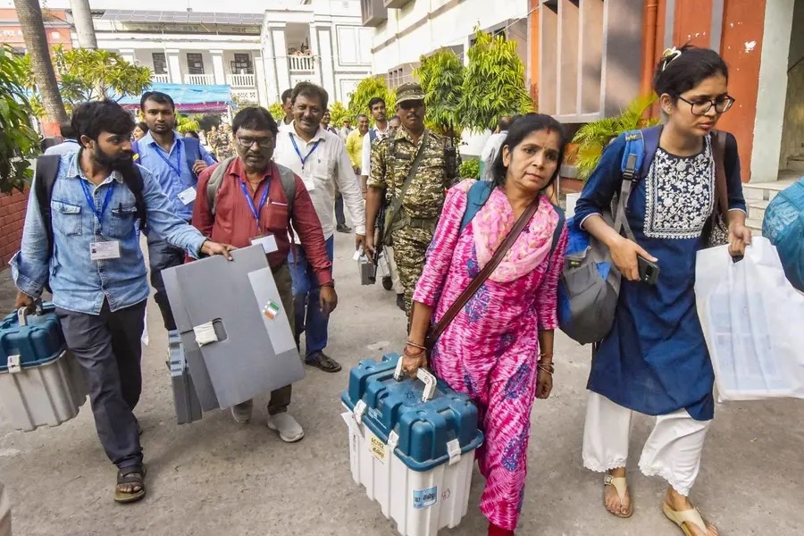 Polling officials with EVM and other election material leave