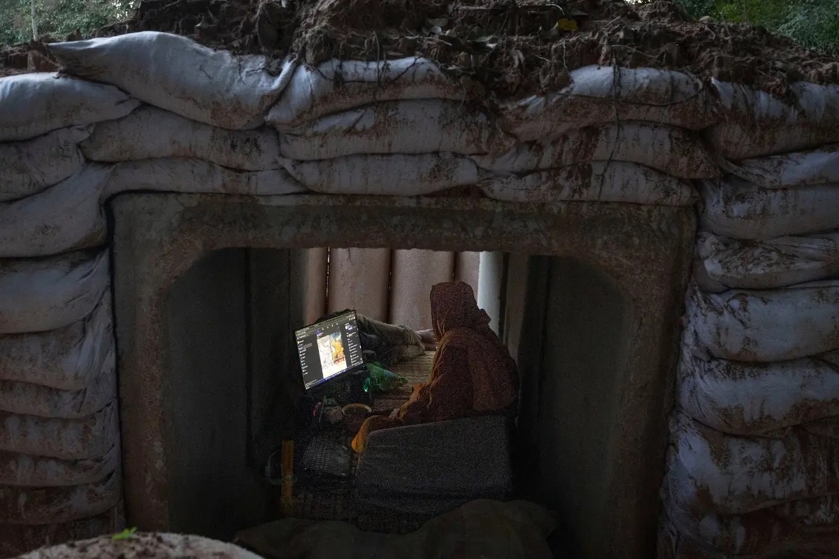 A Thai Buddhist monk uses his computer while taking shelter in Buriram province