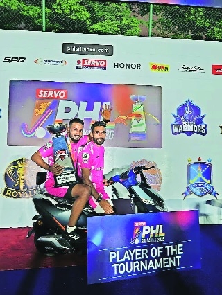 Police Warriors Irshad Mirza  and player of the tournament Niyaz Rahim sit on the moped
