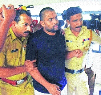 Police personnel take Anandu Krishnan an accused in the CSR fund scam to a location