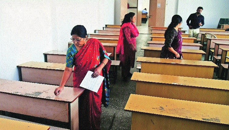 Teachers putting roll numbers on the des