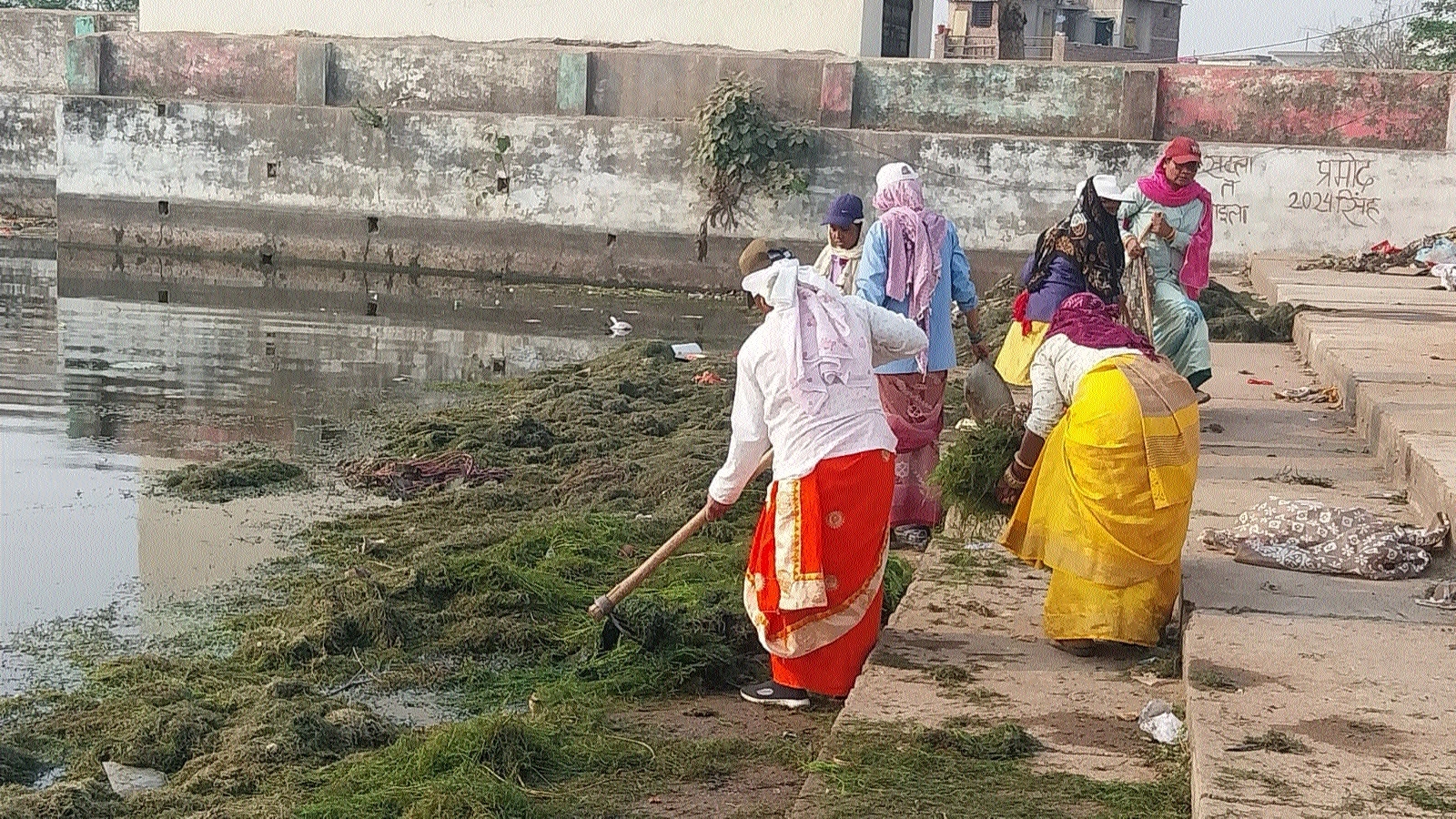 Sanitation workers of RMC cleaning the pond