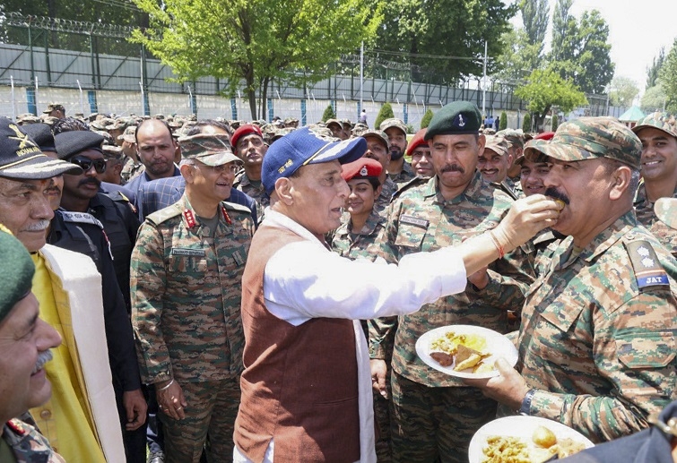 Rajnath Singh offers sweets to an Army officer