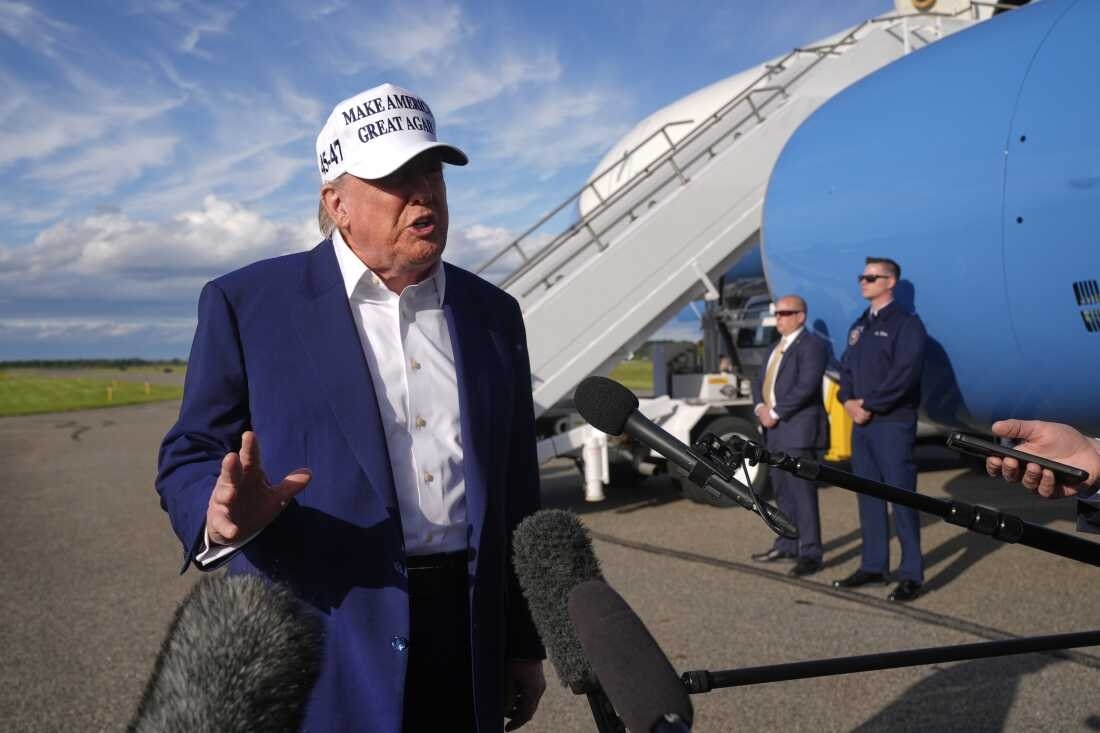 President Donald Trump speaks to reporters before boarding 