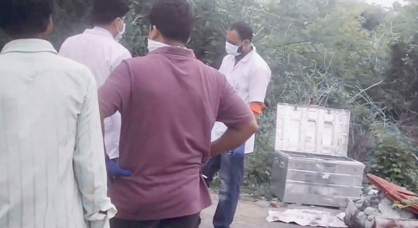 Forensic team recovering the body from suitcase