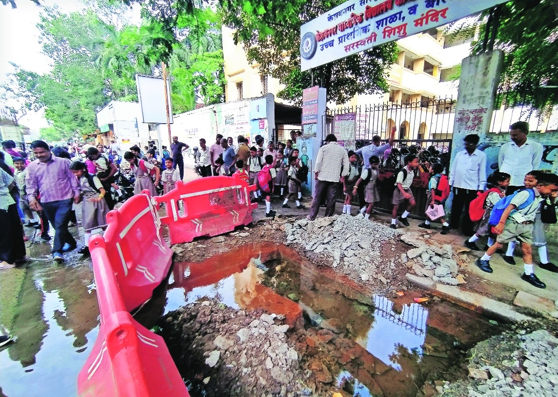 Full of water a crater dug up at entrance of Keshav Nagar School
