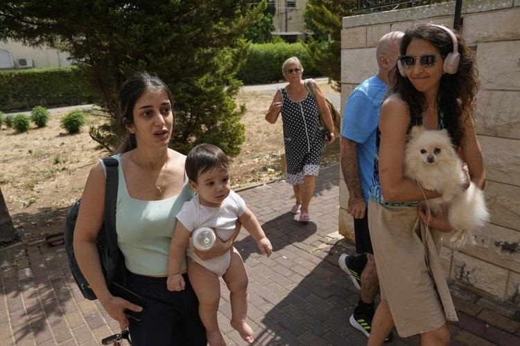People enter bomb shelter a synagogues bomb shelter as air raid