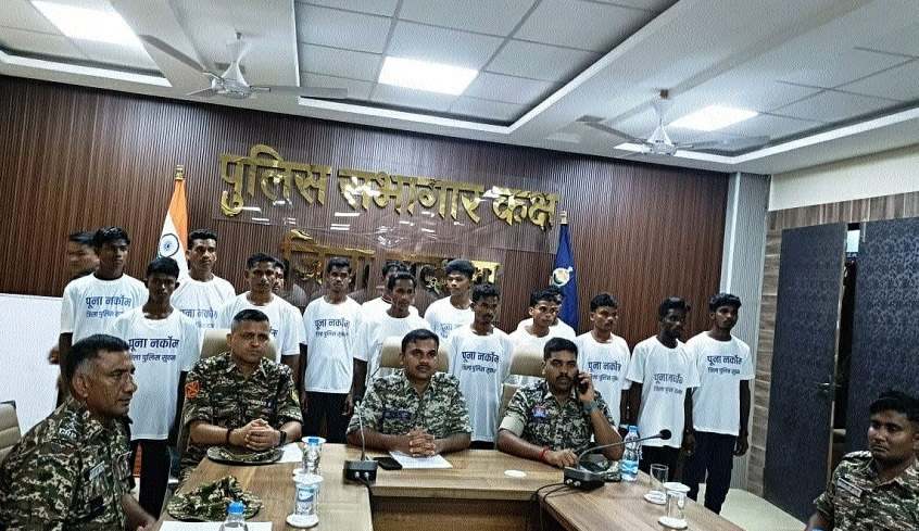 Surrendered Naxals standing behind officials