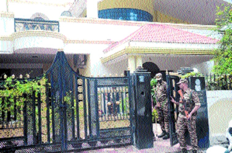 Security personnel standing at the gate of house where raid took place on Tuesday morning