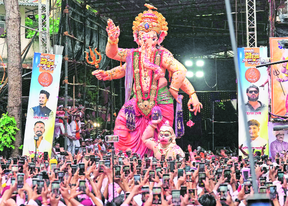 With dhol-tasha and gulal clouds
