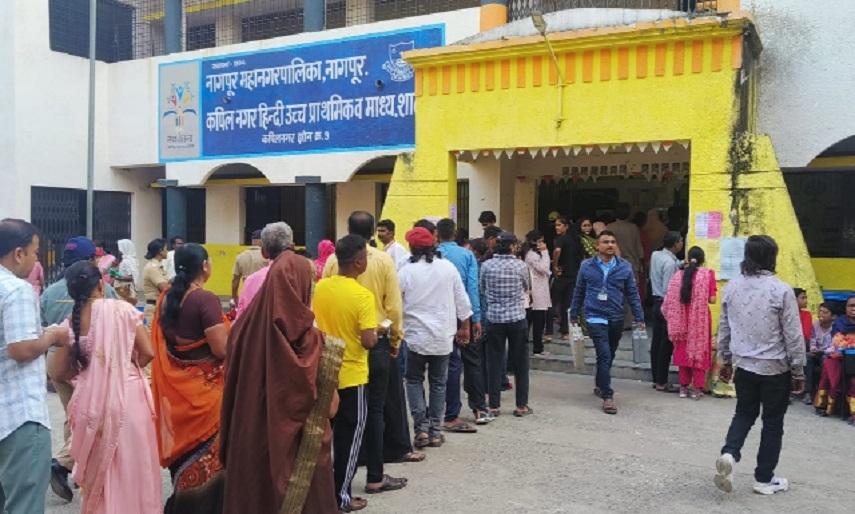 An official taking a faulty EVM away from the polling booth