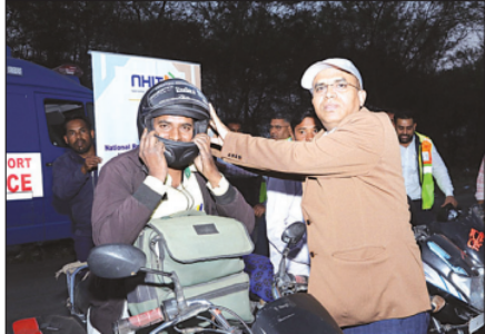 NHAI distributes helmets to two- wheeler riders