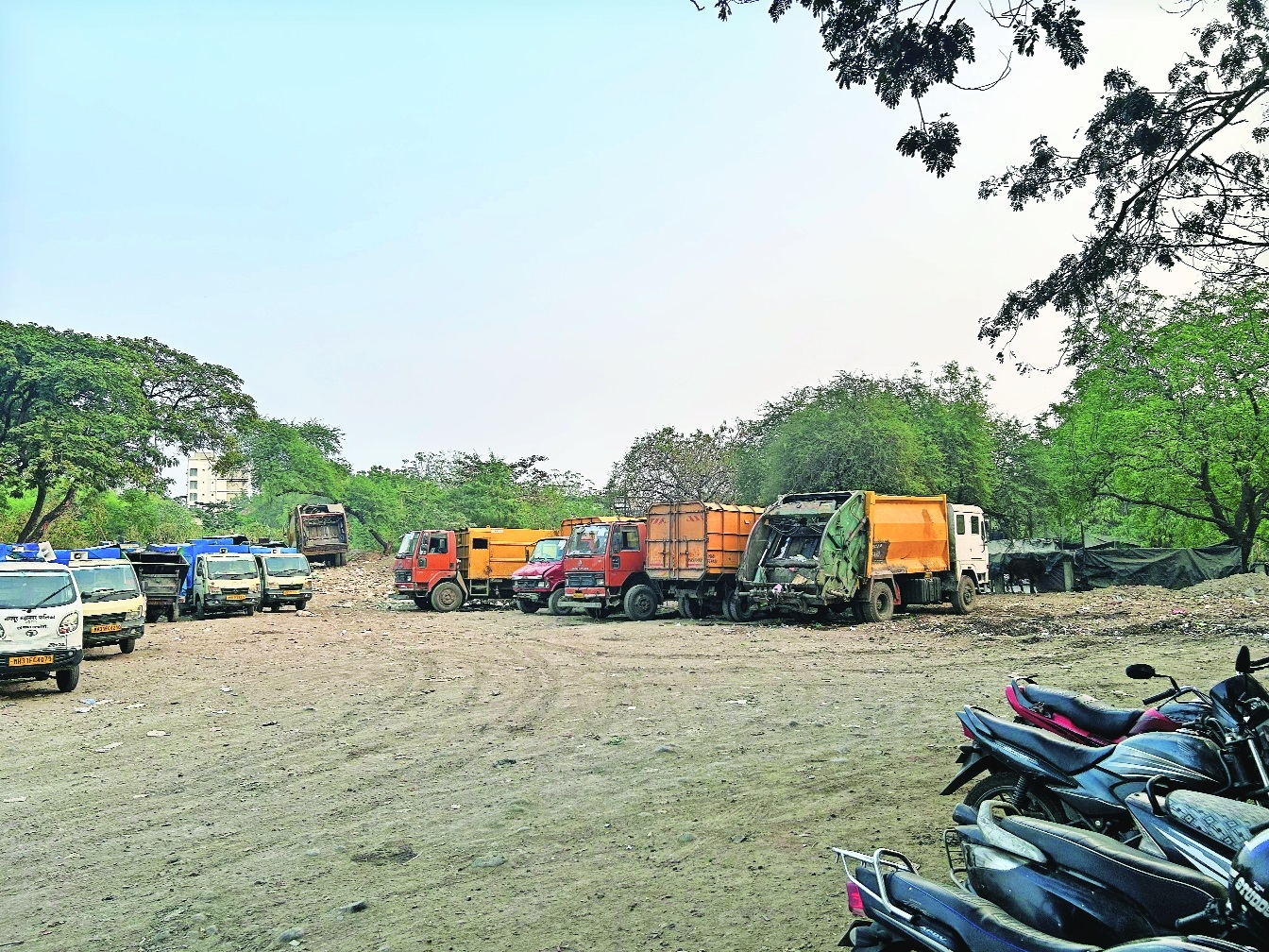 The garbage trucks parked at the open ground in Malviya Naga