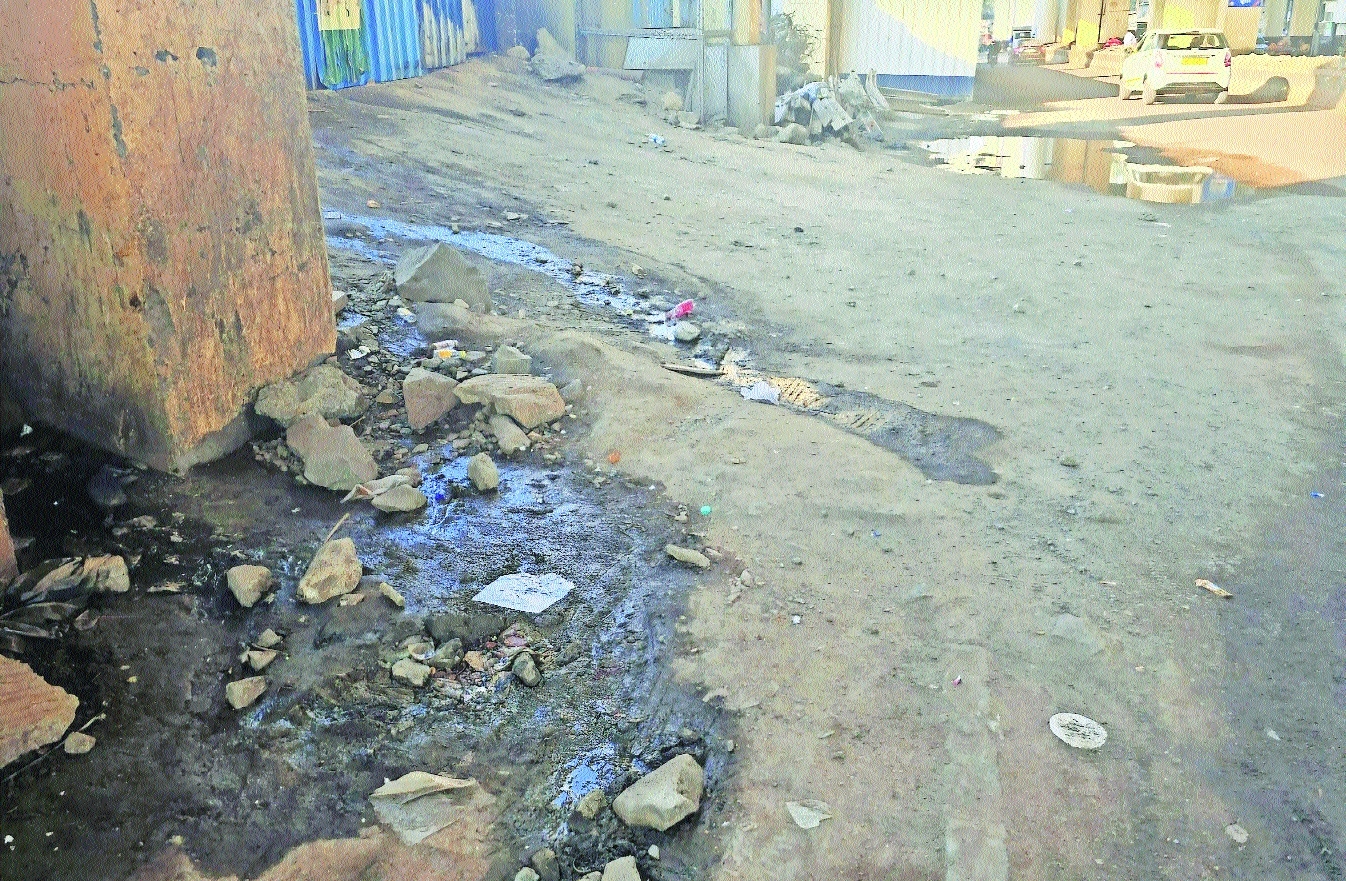 Stagnant sewage mixed with mud and scattered debris spreads turning a busy access