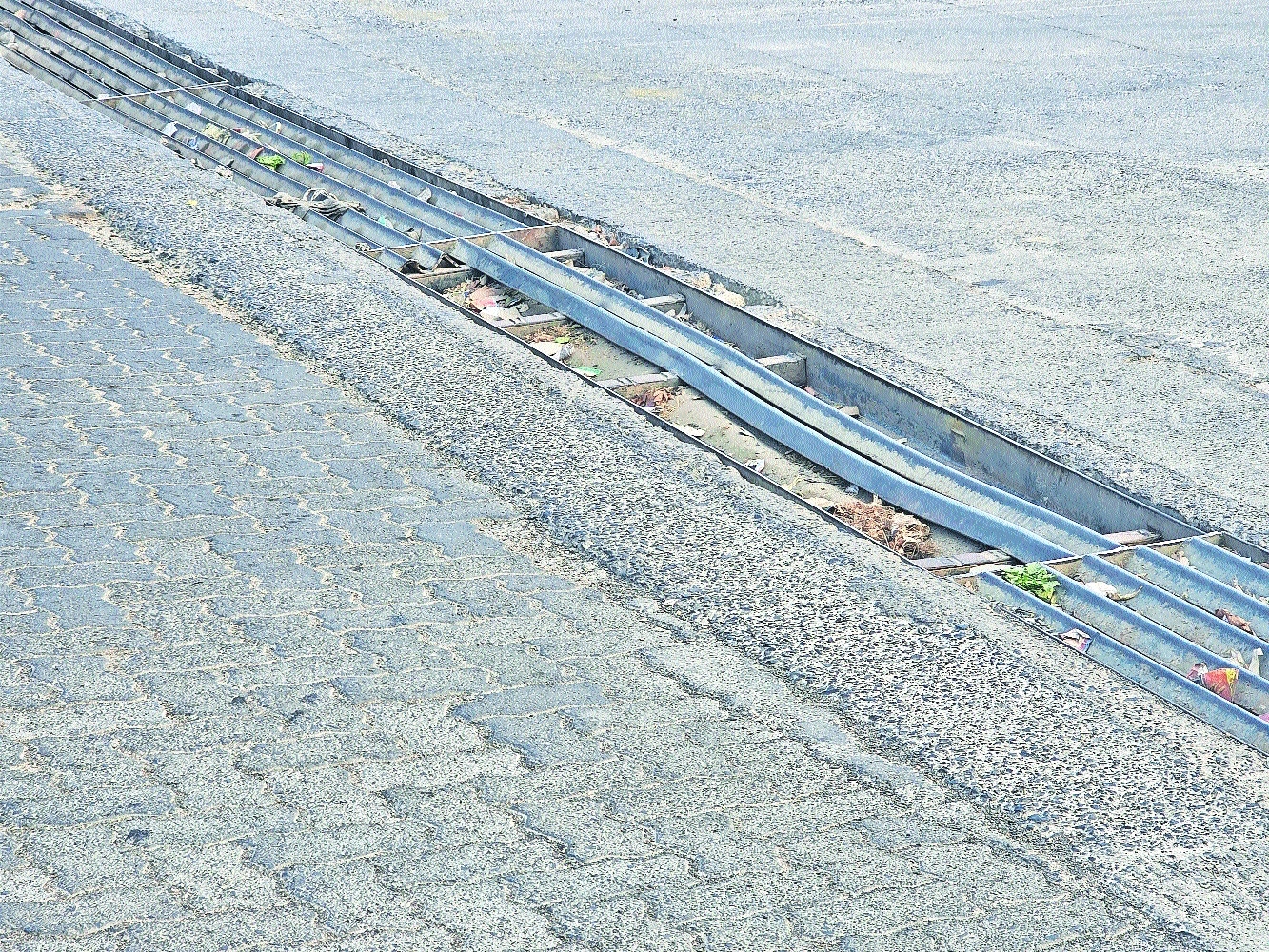 Dangerously exposed stormwater drain at Maharajbag Square with bent and 