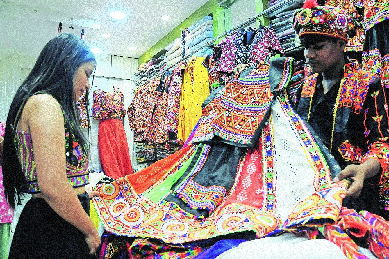 A tough choice A Garba enthusiast looking at a dress at a shop Pic by Satish Raut