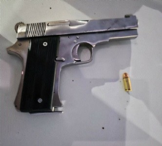 Miscreant held with pistol, live cartridge