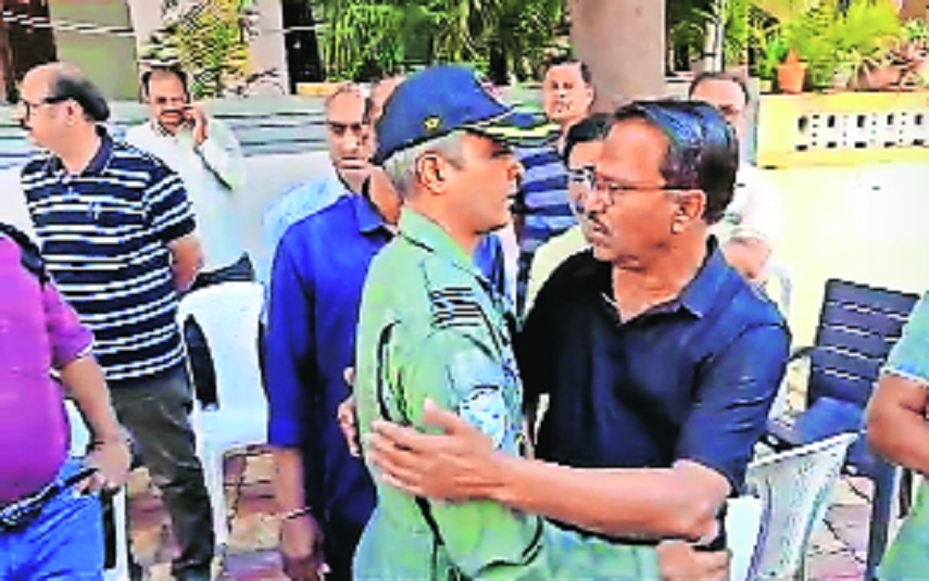 Ravindra Duragkar in black being consoled as he mourns