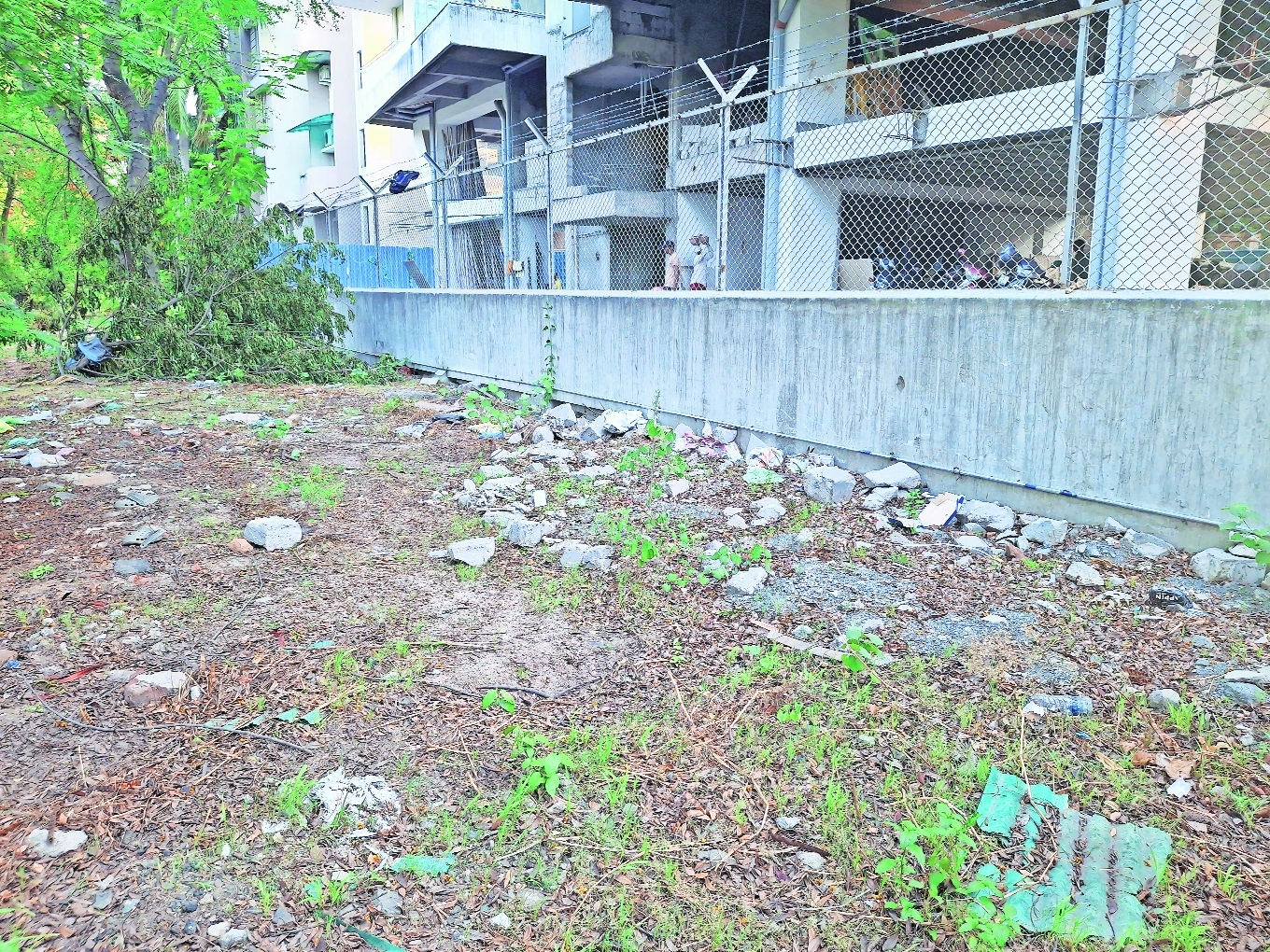 Piece of land outside the construction site where NMC wants to build the sewage chamber