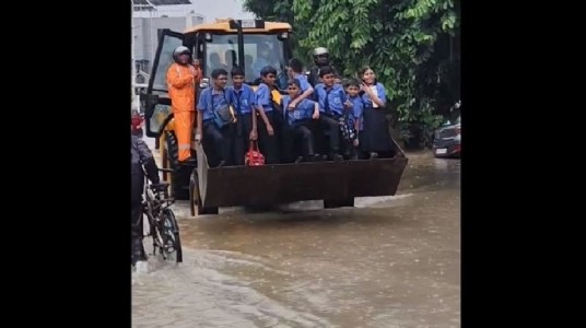 Torrential rains drench city School students rescued using excavator